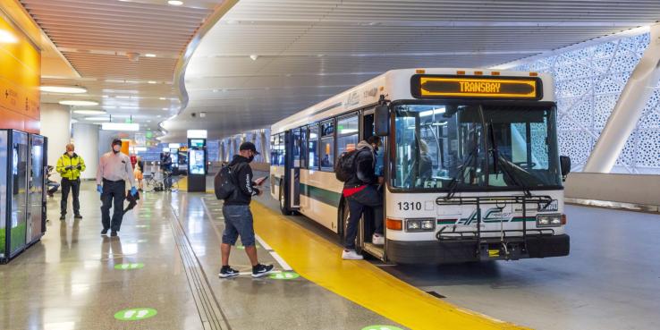 Transit users board the bus at the Salesforce Transit Center.