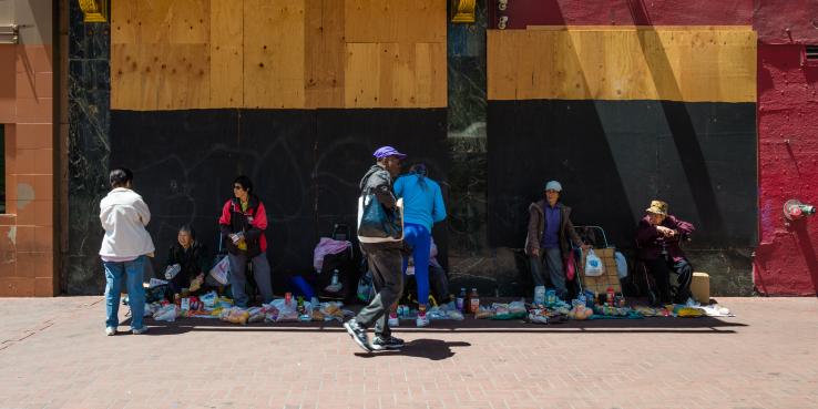 Person walks by a street market. 