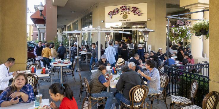 Many people sit outside eating at Pho Ha Noi in San Jose
