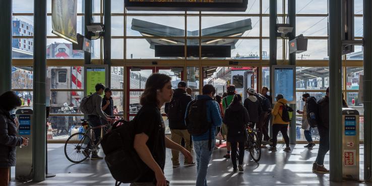 People walking around the SF Caltrain station