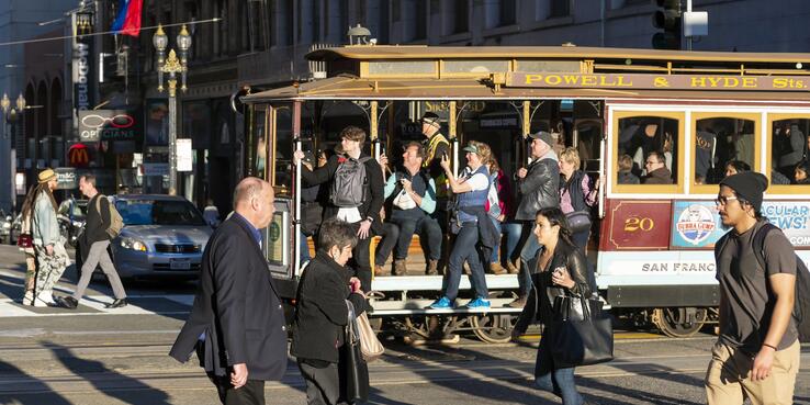 A photo of people on a cablecar on Sutter & Powell St