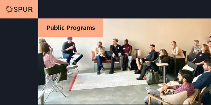 Photo of people gathered around for a book talk at the Urban Center