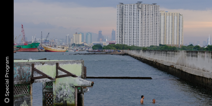 An image of two people swimming in Jakarta near a high-rise
