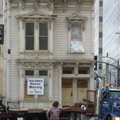 A house being moved, used as a visual pun on displacement