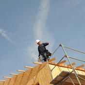 man walking across building under construction