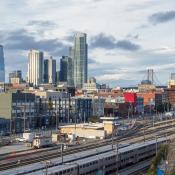 View of Caltrain railyard, SF, with skyline and bay bridge in baxkground