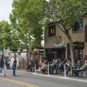 Valencia St, San Francisco - people walking in the streets, relaxing in the outdoor seating area of a restaurant