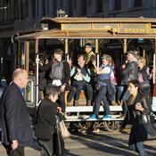 A photo of people on a cablecar on Sutter & Powell St