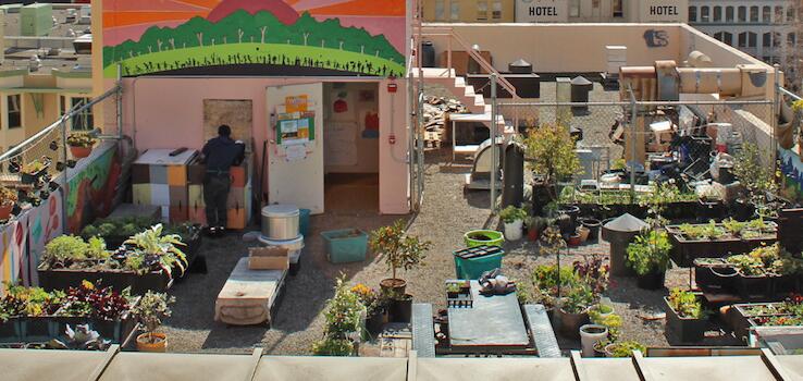 Photo of the San Francisco skyline with a rooftop mural in the foreground.