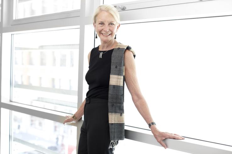 Anne W. Halstead standing by a window of the SPUR Urban Center