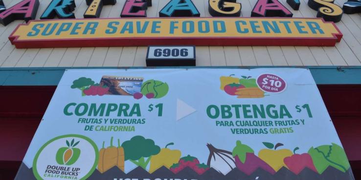 New research shows that programs like SPUR's Double Up Food Bucks, advertised here at Arteaga's Food Center in Gilroy, provide a positive economic boost to local economies. 