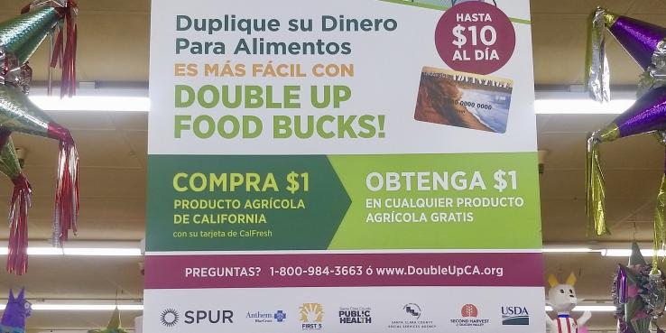 A sign advertising Double Up Food Bucks hangs at Arteaga's Food Center