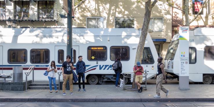 people standing in front of VTA light rail