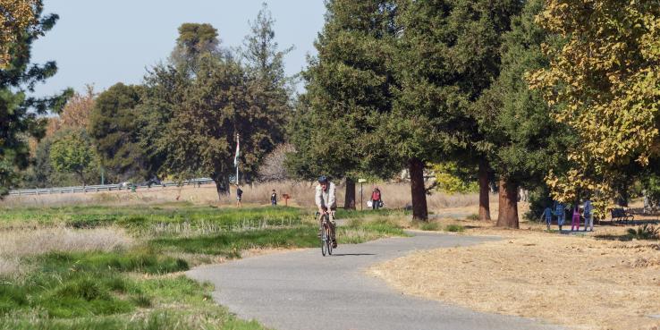 people biking on a trail at guadalupe river park in san jose
