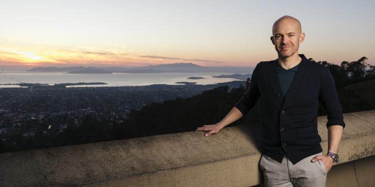 Photo of Noah Christman with a view of San Francisco Bay behind him