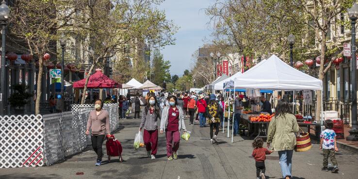 People shopping at an outdoor farmer's market