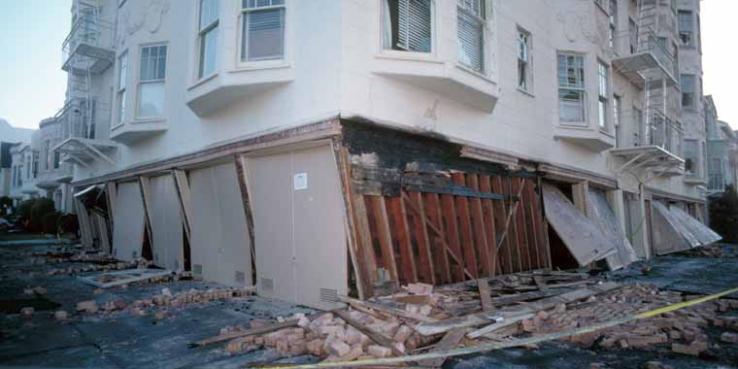 Absence of adequate shear walls on the garage level exacerbated damage to this structure at the corner of Beach and Divisadero Streets, Marina District. [J.K. Nakata, U.S. Geological Survey]