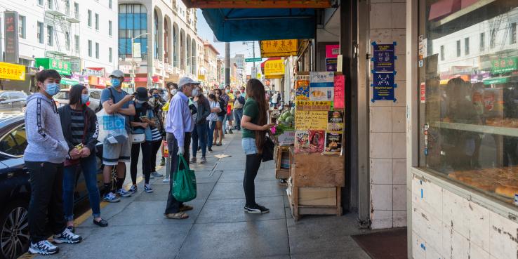 people grocery shopping on stockton street in sf