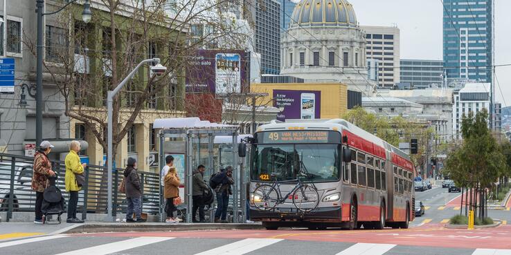 Riders boarding a Muni train on Van Ness Avenue