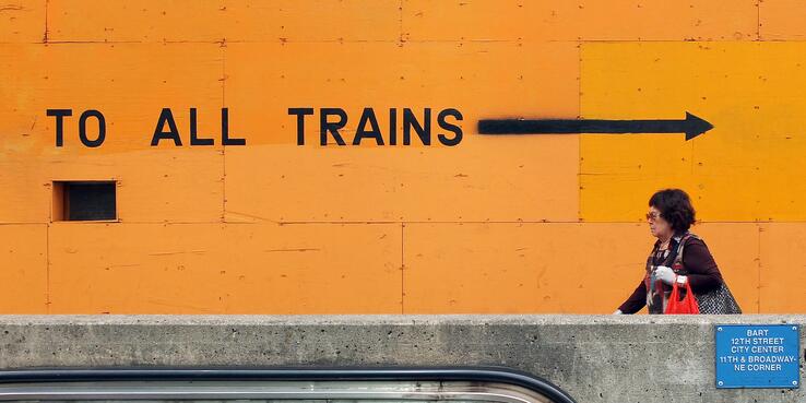 Person walking past transportation construction signs