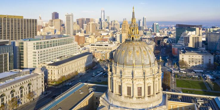 San Francisco City Hall cupola with downtown skyline in the background