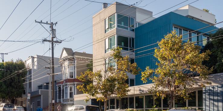 Electricity poles and wires connecting to an apartment building