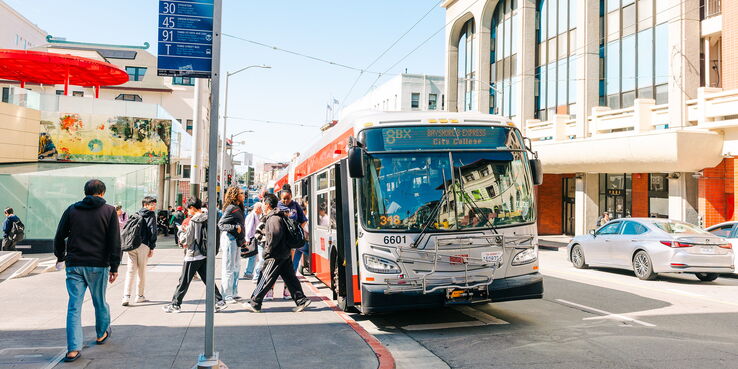 riders boarding a Muni bus in San Francisco Chinatown