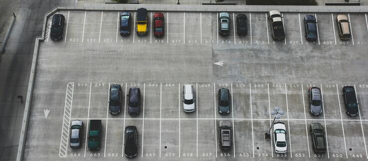 A mostly empty parking lot viewed from above