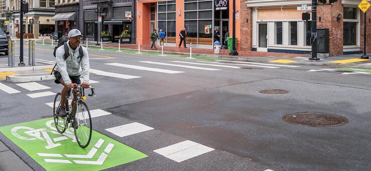 bicycle rider in a green bike lane on an urban street