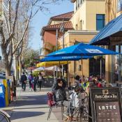 Downtown San José sidewalk with cafes and people relaxing outside