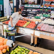 High Angle View Man Selecting Tomatoes in Grocery Store